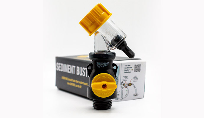 Sediment buster valve with yellow handle in front of product packaging